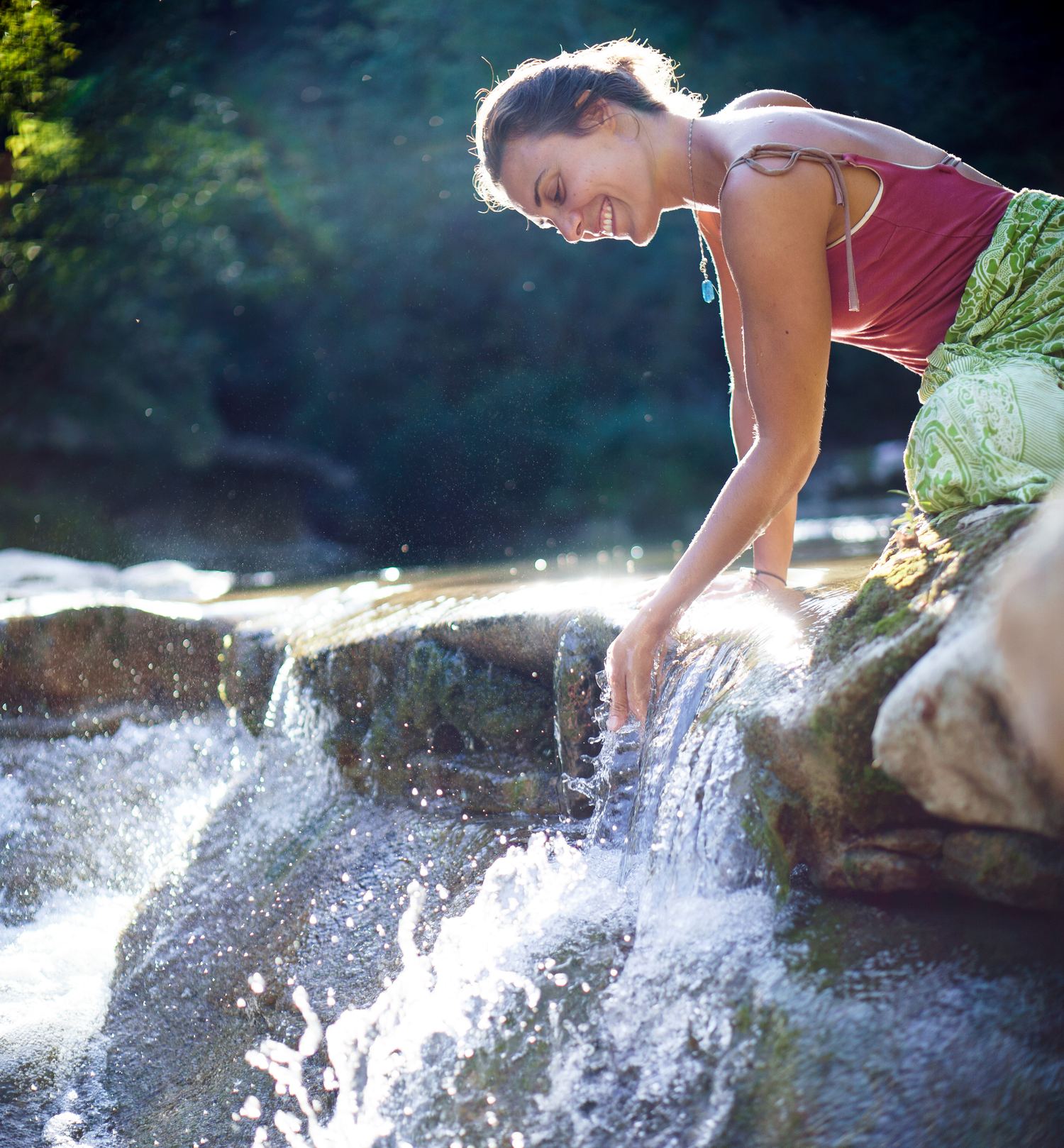 L'insegnante di yoga raccoglie l'acqua del fiume con le mani